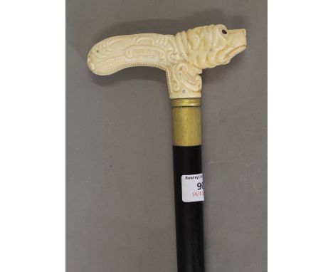 A walking stick with a carved bone dog formed handle. 89.5 cm high.