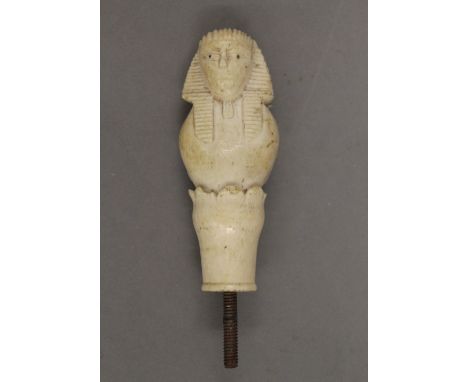 A 19th century ivory walking stick handle carved as an Egyptian figure. 8.5 cm high. 