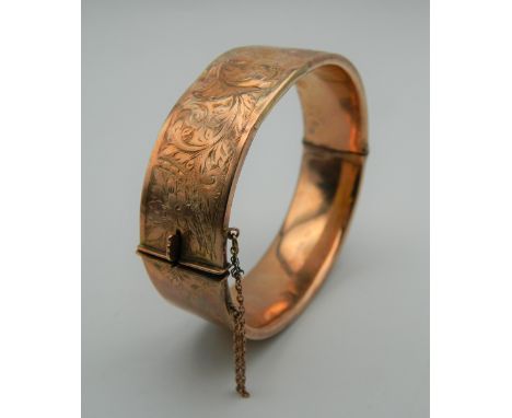 A 9 ct gold bangle form bracelet. 7 cm wide. 24.9 grammes.