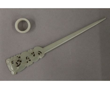 A jade hair pin and ring. The former 16 cm long.