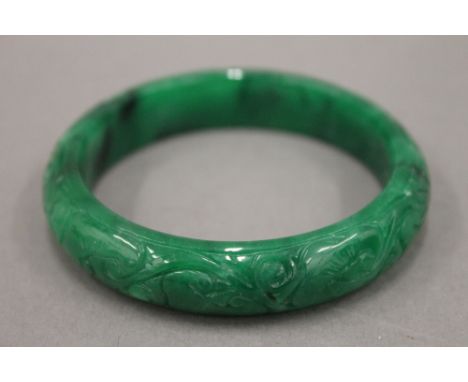 An apple green jade bangle. 7 cm diameter.