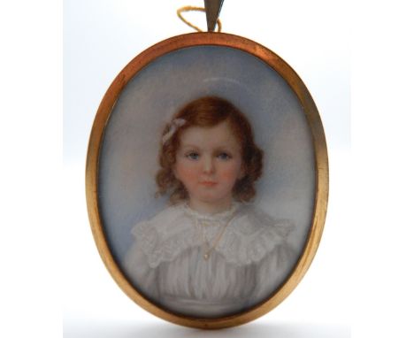 A 19th century portrait miniature on ivory of a young girl, framed. 5.5 cm wide.