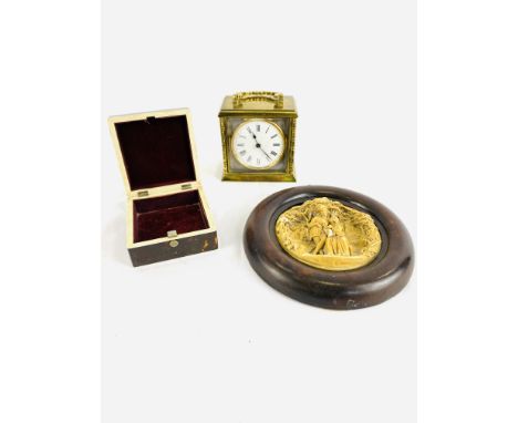 A brass cased carriage clock with enamel dial, not going; a soapstone carving in a wood frame, 18cm diameter; a tortoiseshell
