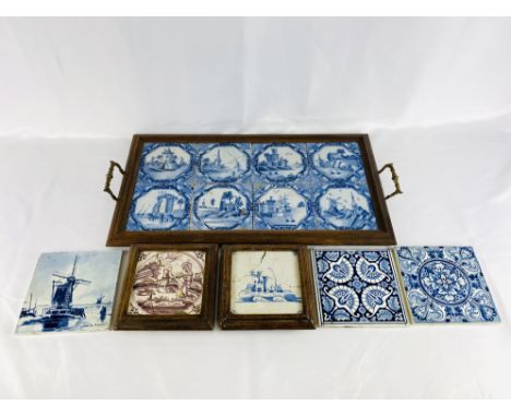 A wood framed tray with eight blue and white Delft tiles, 62 x 30cm; two framed tile teapot stands, each 17 x 17cm; a Delft t