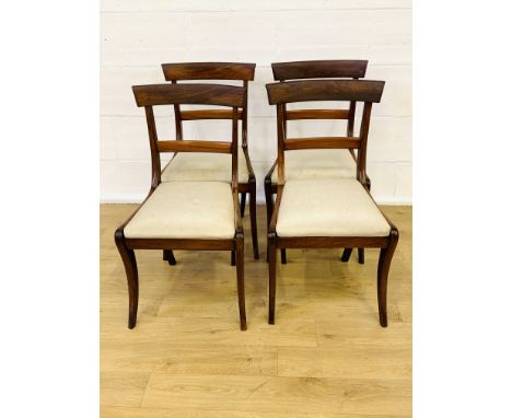 Four mahogany ladder back dining chairs with sabre legs to front and upholstered drop in seats, 47 x 48 x 86cms. Estimate £25