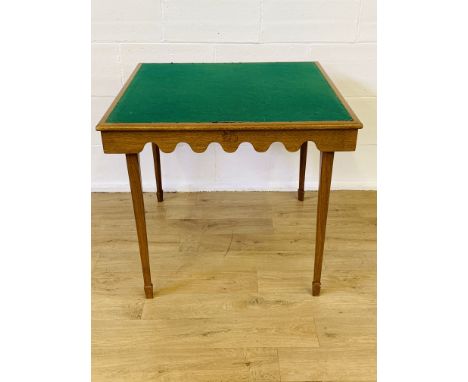 Oak folding card table with inscribed squirrel to one side, on tapered legs to spayed feet, 87 x 87 x 75cms. Estimate £20-40.