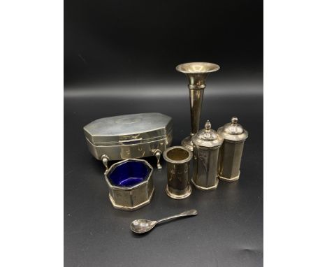 A silver jewellery box with engine turned lid on four legs, 1926; a silver bud vase, 1979; silver three piece cruet, 1996, 5o