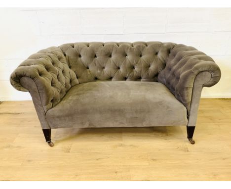 Chesterfield sofa upholstered in mushroom fabric on tapered legs to castors, 155 x 90 x 75cms. Estimate £60-80.