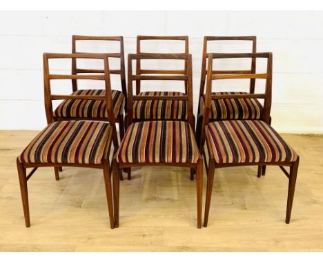 Six teak ladder back dining chairs with upholstered drop in seats, 49 x 52 x 85cms. Estimate £40-60.