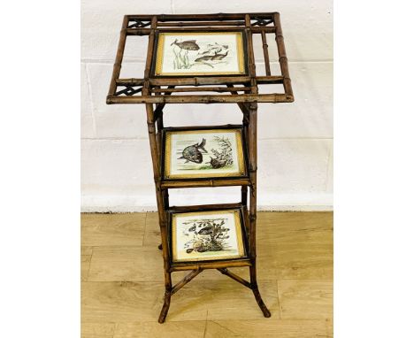 Bamboo three tier wotnot with ceramic tile shelves decorated with fish, 38 x 38 x 75cms. Estimate £20-40.