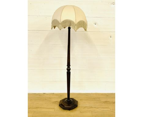 Oak standard lamp on turned stand to octagonal base with shade, 158cms. Estimate £20-40.
