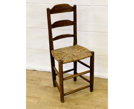 Child's mahogany ladder back chair with string seat on turned legs, 37 x 30 x 85cms. Estimate £20-40.