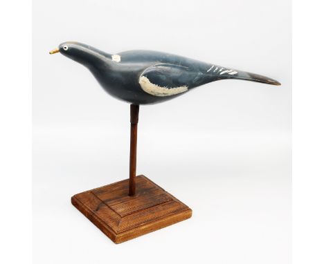 An early 20th century wooden decoy model of a Pigeon, painted grey with white detail and yellow beak, in the manner of Truloc