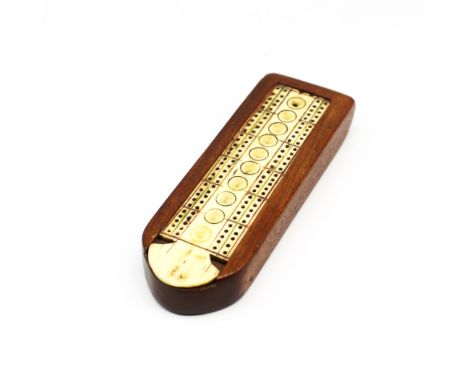 An early 19th century Napoleonic prisoner of war work carved bone cribbage board. Set within a shaped wooden mount, the board