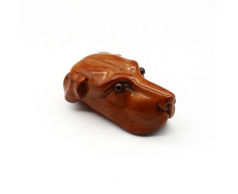 A late 18th/early 19th century carved coquilla nut snuff box, in the shape of a hunting/gun dog, glass eyes and compartment t