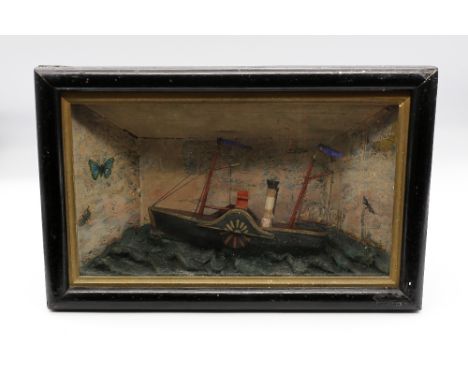 A 19th century cased model of a paddle steamer ship. Housed in a purpose built box frame, the ship is set upon a blue painted