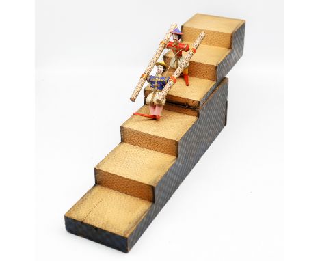 An early to mid 19th century 'tumbling double acrobatic toy', the two acrobats dressed in bright coloured fabrics with metal 