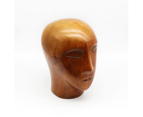 A late 19th / early 20th century carved sycamore wooden milliners model head, carved eyes, nose and mouth, approx. 23cm high 