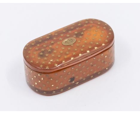 An early 19th century oblong shaped blonde tortoiseshell small snuff box, inlaid with yellow metal star design and central ov