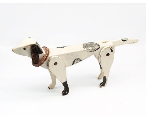 An early to mid 20th century painted wooden articulated model of a Dalmatian, of traditional white and black spots colourway,
