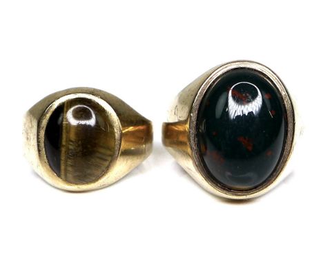 Two 9ct gold gentlemans' rings, the first set with an oval bloodstone of 1.7 by 1.2cm, size R, the second set with a tiger's 