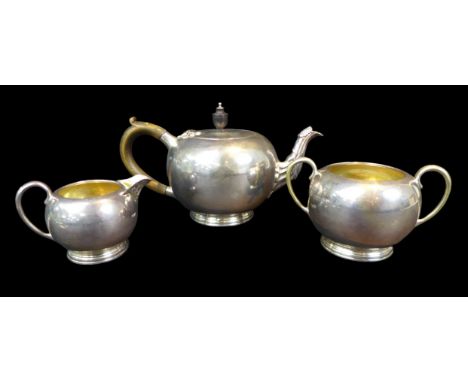 A Victorian silver three-piece bachelor's tea set, the bullet shaped teapot, 24 by 13 by 13cm high,  twin handled sugar bowl,