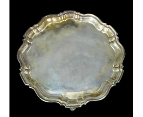 A George V silver tray, of circular form with Chippendale pie crust edge, raised on three scroll feet, Ellis &amp; Co (Ellis 