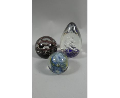 A Collection of Three Glass Paperweights to Include Caithness 