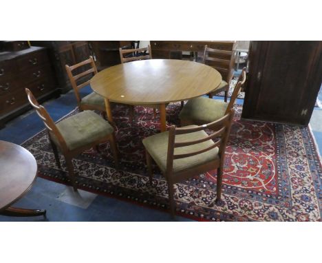 A Schrieber Circular Drop Leaf Dining Table and Six Matching Ladder Back Chairs 