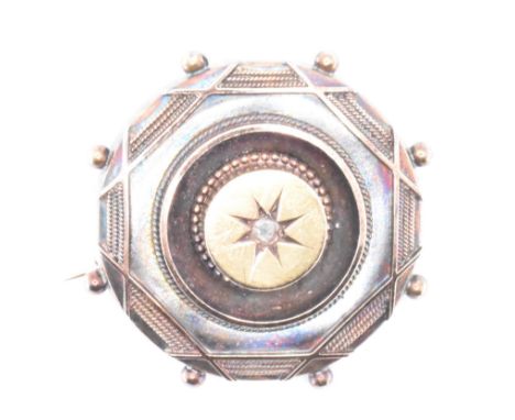 A 19th Century Victorian mourning brooch. The brooch having a glazed panel to the verso, set with a central rose cut diamond 