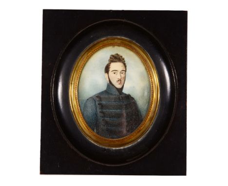 FRENCH SCHOOL (19TH CENTURY) A miniature oval portrait of a young officer with coiffed hair and beard, and brocaded tunic, wa