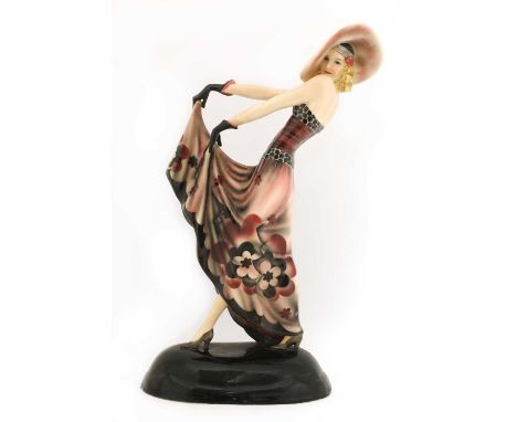 A Goldscheider pottery figure of a lady in a hat,modelled by Stefan Dakon, holding her dress and striking a pose, on a domed 