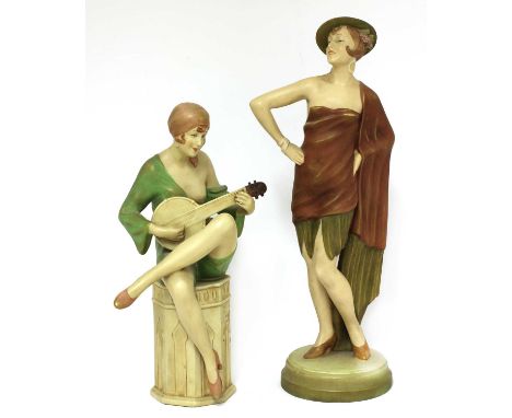 Two Royal Dux pottery figures of ladies,a lady striking a pose,35.5cm high, the other of a lady seated on a pedestal playing 