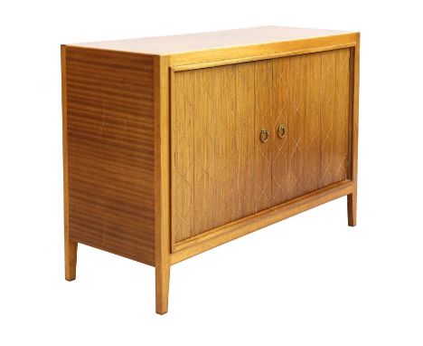 A Gordon Russell 'Helix' sideboard,designed by David Booth and Judith Ledeboer in 1951, the routed cupboard panels enclosing 