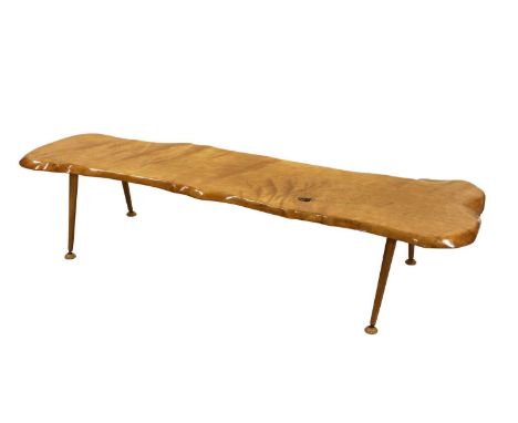 A tree trunk coffee table, with turned supports and 'Armstrong Cork Company' button feet,164cm wide53cm deep35cm high