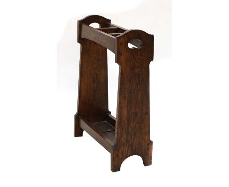 A Liberty oak stick stand,with three divisions, pierced ends, and a tray base, 55.5cm wide20cm deep73cm highCondition report: