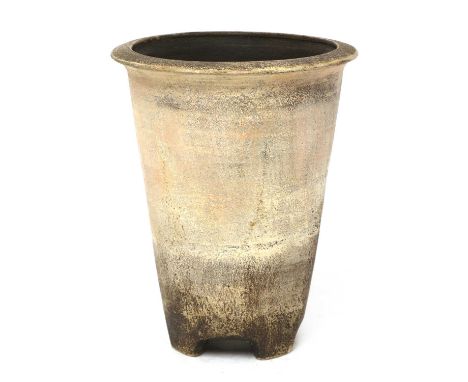 *Hans Coper (German, 1920-1981),a stoneware tapering vase, with a flared rim, on lug feet, unmarked, restored, 23cm highProve