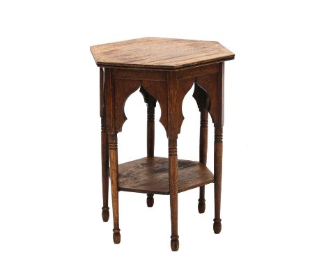 An Arts and Crafts hexagonal oak lamp table,the plain top with an arcaded apron raised on turned supports, 35.5cm diameter51c