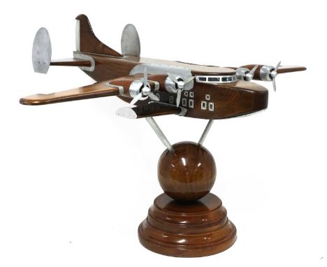 A model of a Pan American Boeing 314 Clipper floatplane, constructed in mahogany and brushed aluminium, with propellers, rais