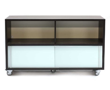 A contemporary walnut veneered side cabinet,with a shelf, over two glass sliding panels, on high castors,145cm wide41cm deep8