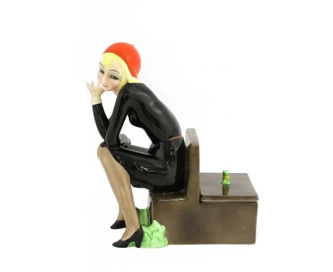 A Lenci 'Nella' figure,modelled by Helen König Scavini, as a lady seated on a bench, the reverse forming a box with a cover s