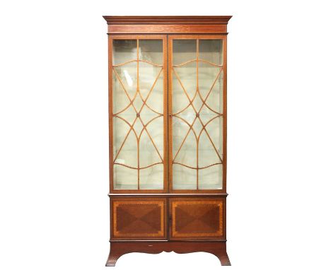 A mahogany inlaid cabinet,in the manner of George Jack, with three-quarter glazed doors, with a cupboard below, 95cm wide34cm