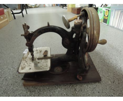 A vintage Willcox and Gibbs hand cranked sewing machine