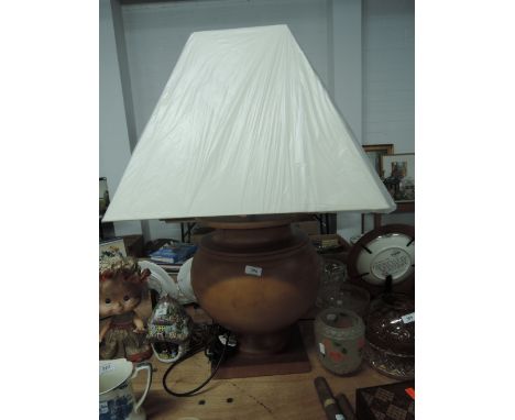 A large modern wood lamp and shade