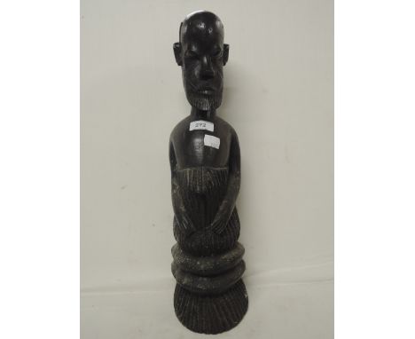 A vintage tribal ethnic figure hand carved and worked in heavy lignum style wood