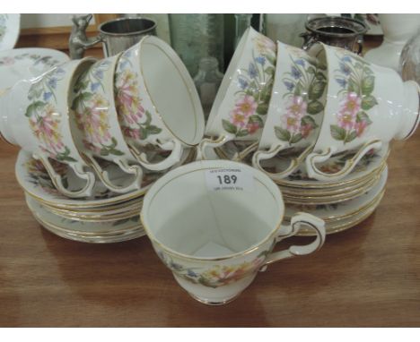 A selection of tea cups and saucers by Paragon in the Country Lane pattern