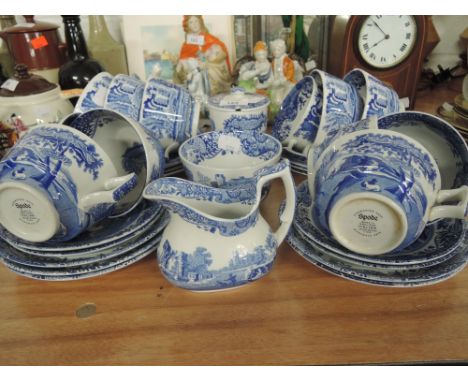 A selection of large tea cups and saucers by Spode blue and white Delftware style design