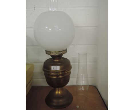 A vintage brass bodied oil burner light with opaline lamp shade