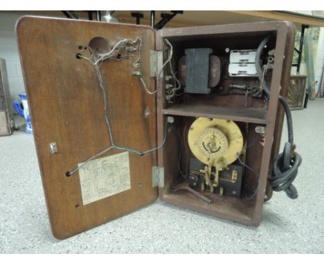 A vintage bell and timer system housed in treen casing with brass workings marked Ericsson 