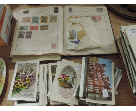 A selection of vintage world stamps and collectable postcards 